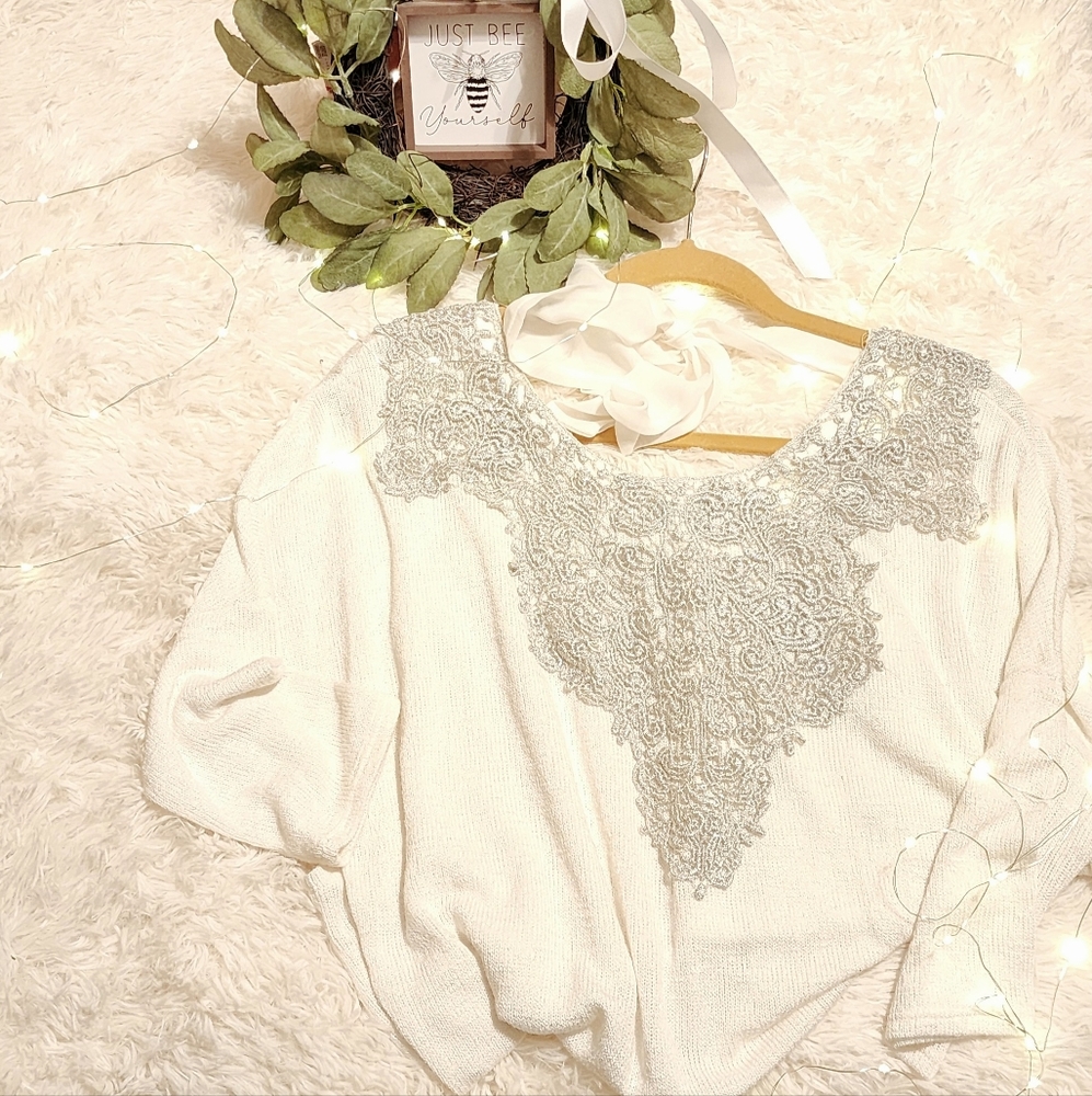 White sweater with silver embellishments and tie back